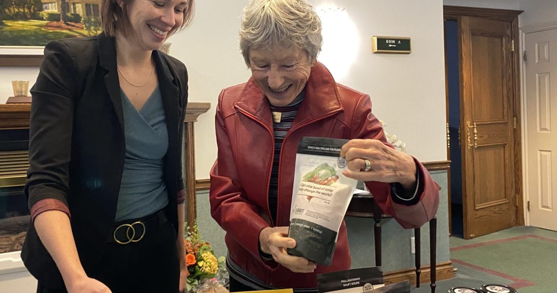 Raw Carrot community engagement manager Elena Haskell and St. Andrew's Barrie's Penny Barker restock the sales table and talk about the seasonal flavours of the heart-warming soups.