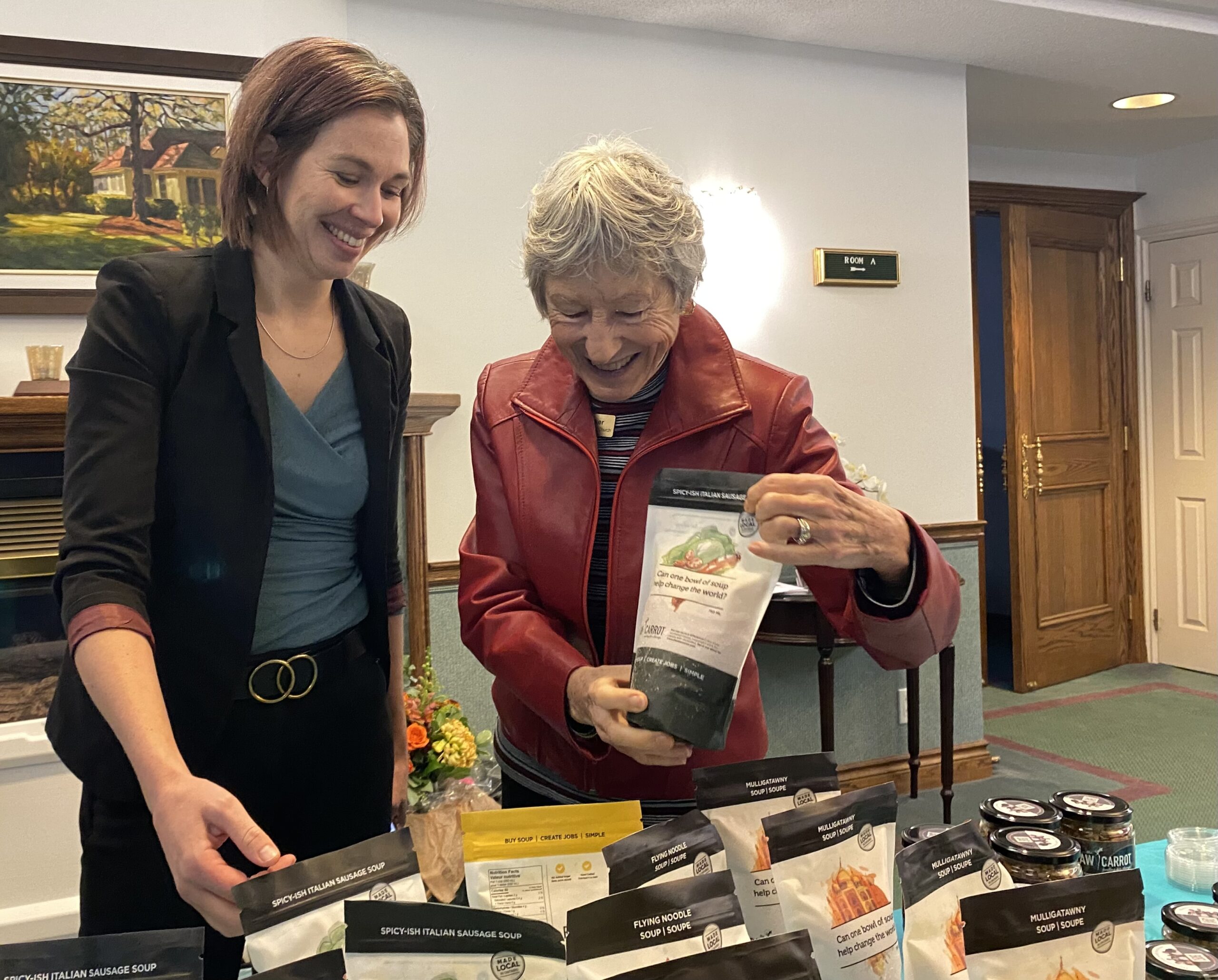 Raw Carrot community engagement manager Elena Haskell and St. Andrew's Barrie's Penny Barker restock the sales table and talk about the seasonal flavours of the heart-warming soups.